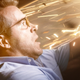Ryan Reynolds drives with sparks flying toward him in a scene from Free Guy.